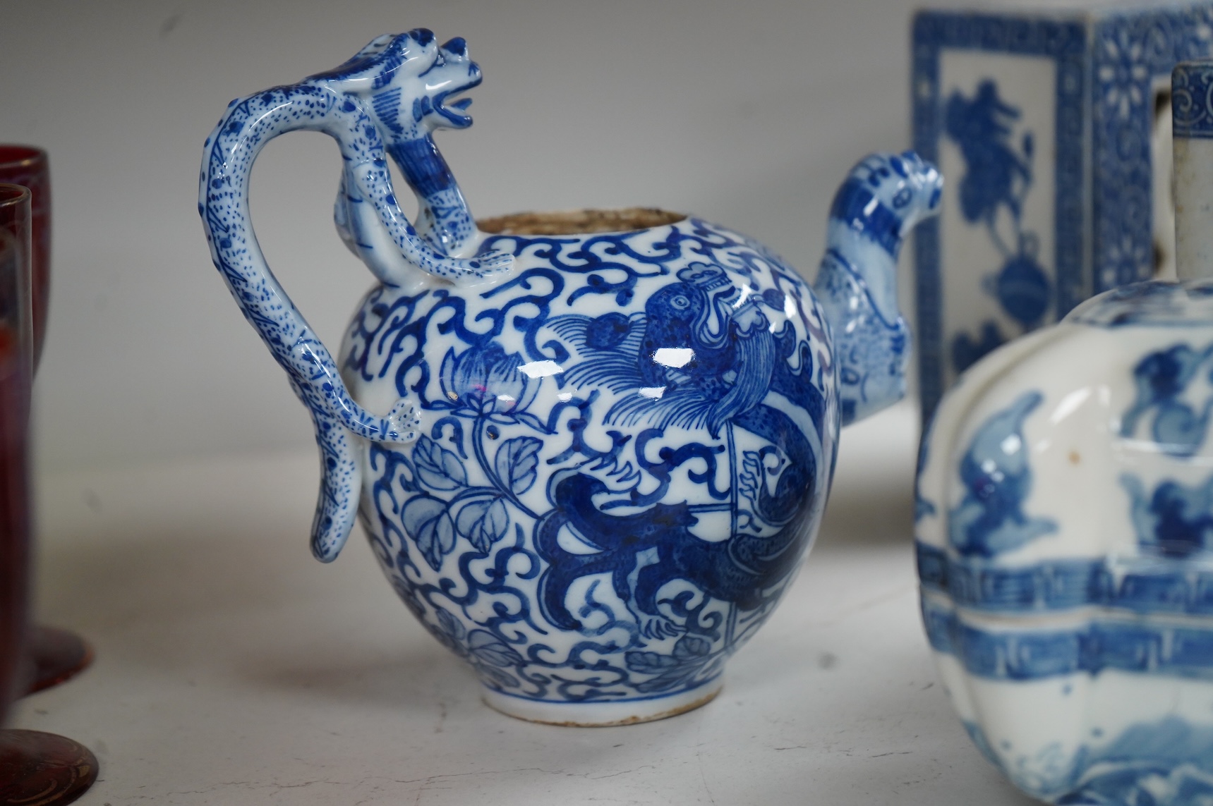 A group of Chinese blue and white comprising a dish and cover, two pillows, waterdropper and a teapot, largest 26cm wide